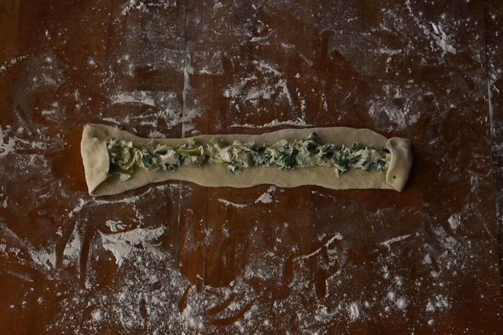 dough with filling on it and the ends folded over