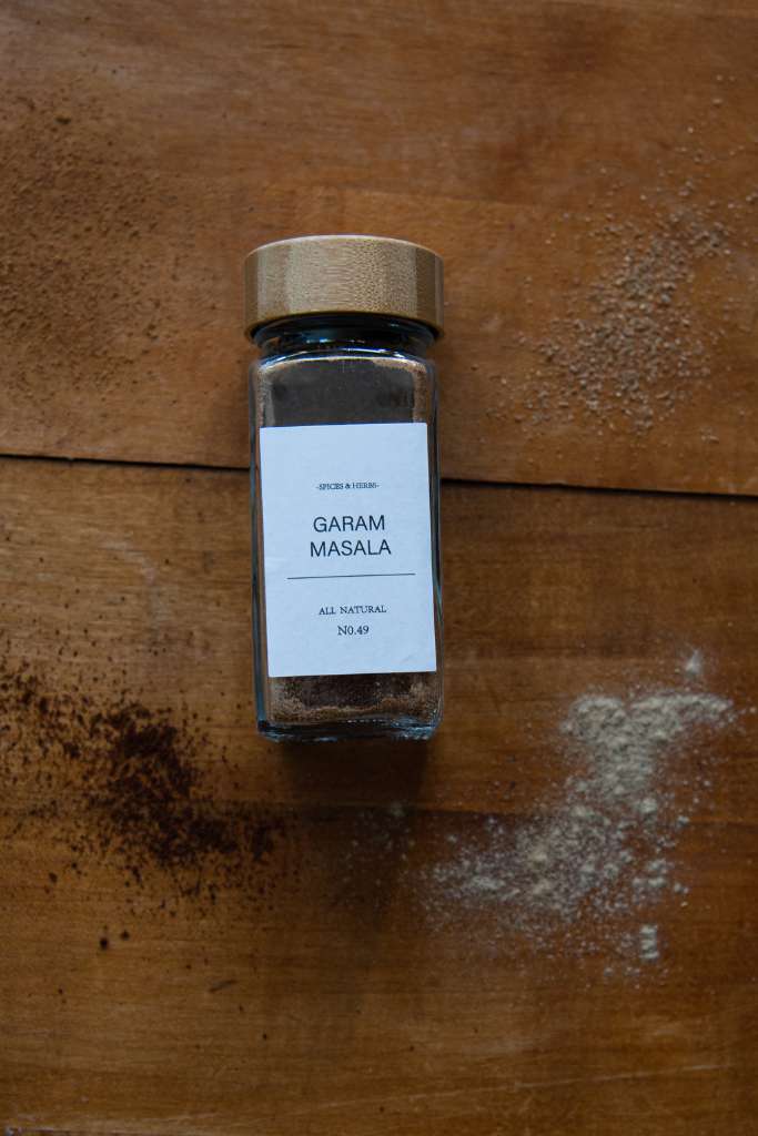 a bottle of garam masala laying on a table