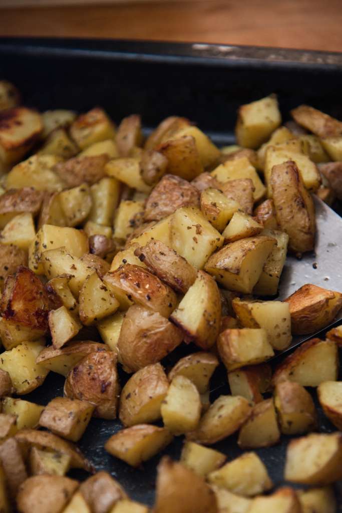 a spatula of potatoes over a pan of potatoes