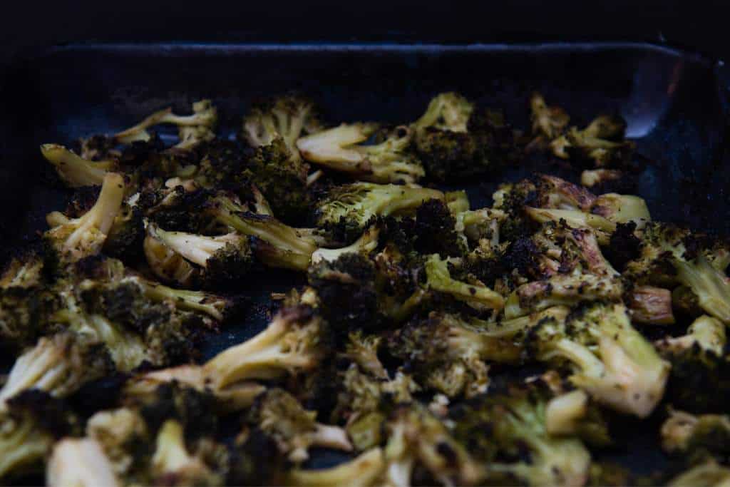 a close up of a baking sheet of broccoli