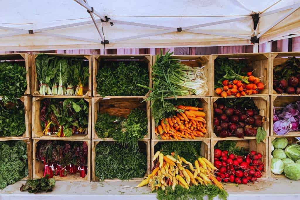 stock image of local farmers harvest at a stand at the farmer's market