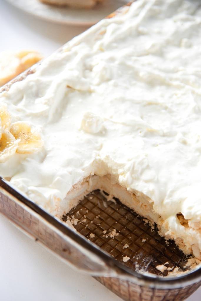 a close up of a pan of banana torte that has two pieces taken out of it 
