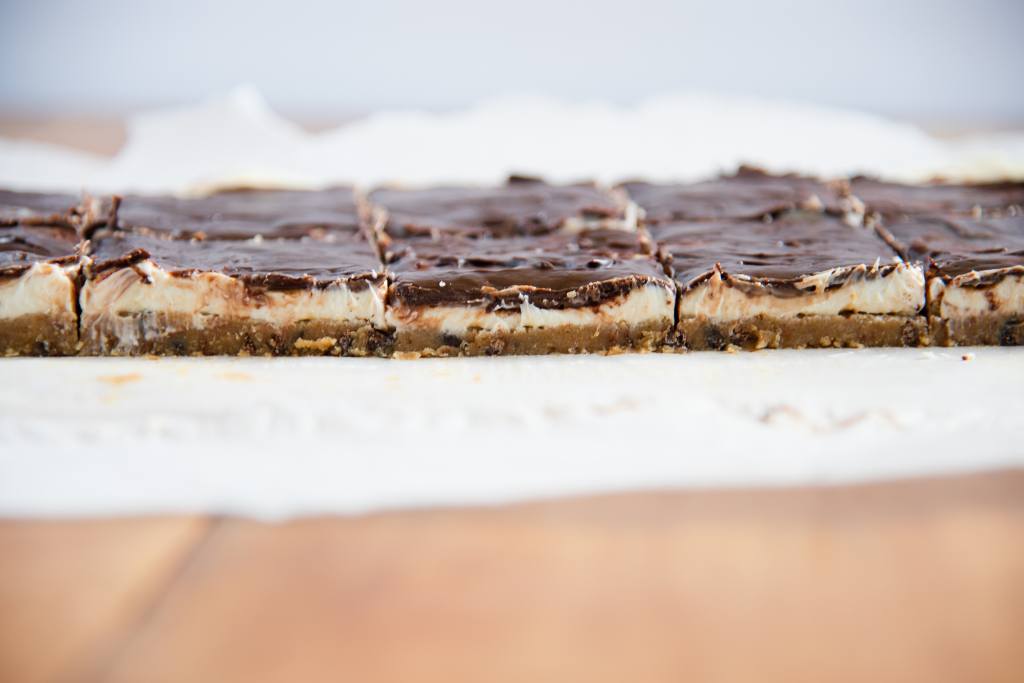 a close up of sliced cheesecake bars, you can see the filling.