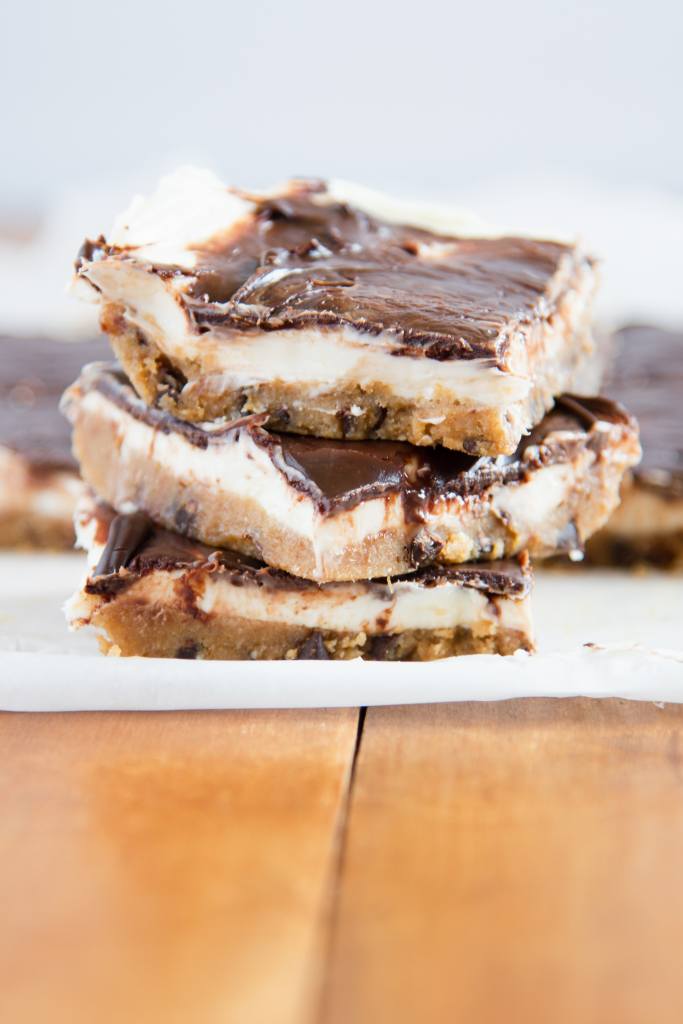 three cheesecake bars staked on top of each other. You can see the rest of the bars behind them