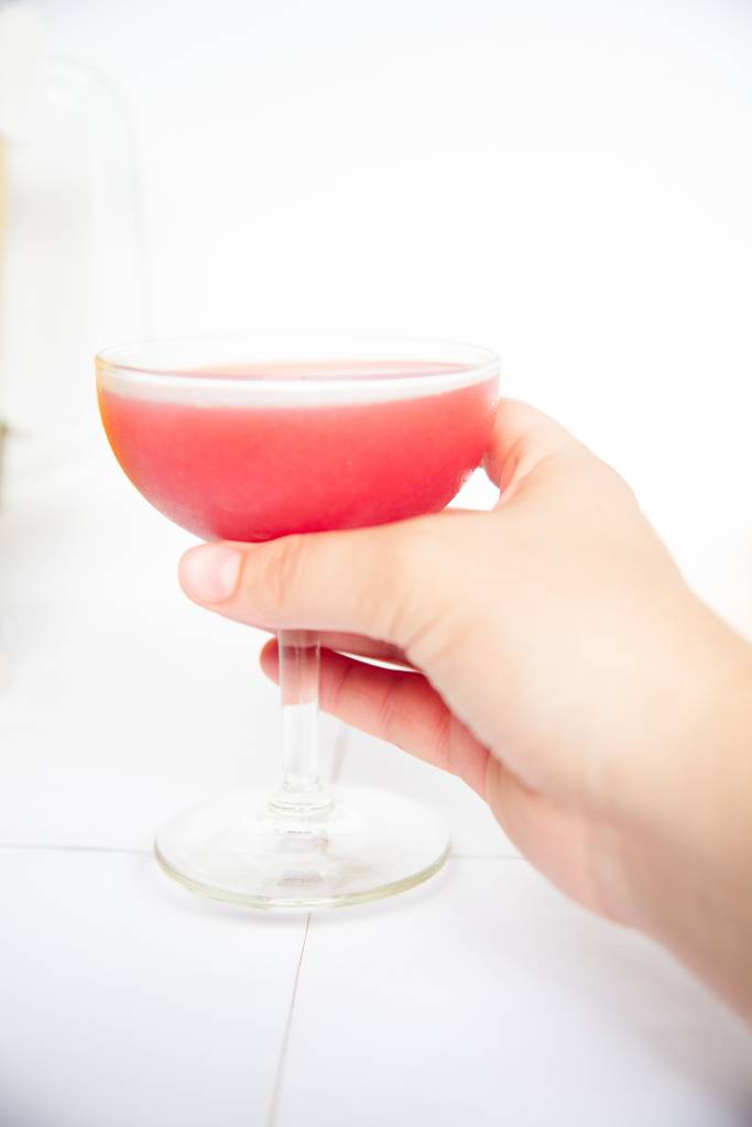 someone holding a Rosie's Cocktail