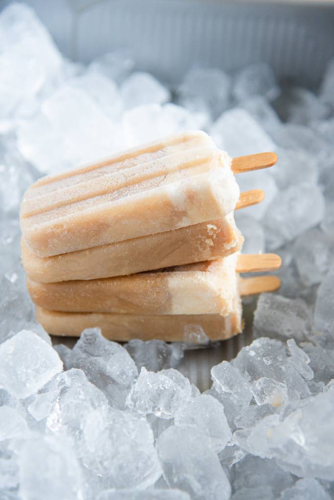 four ice cream bars stacked on top of each other in a dish of ice