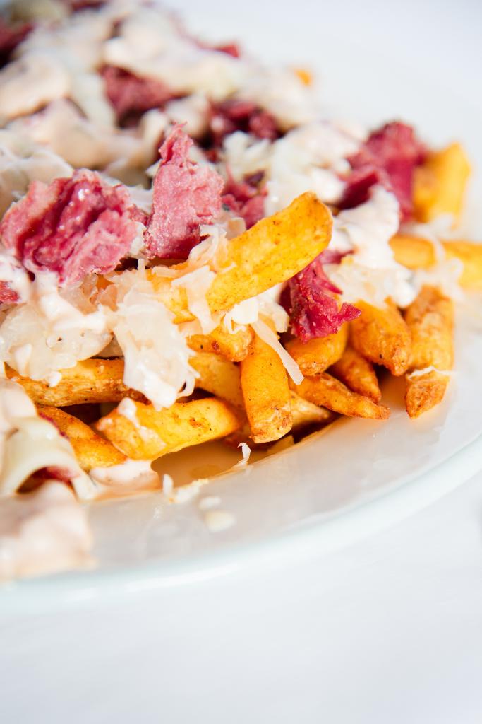 a close up of a loaded reuben fries