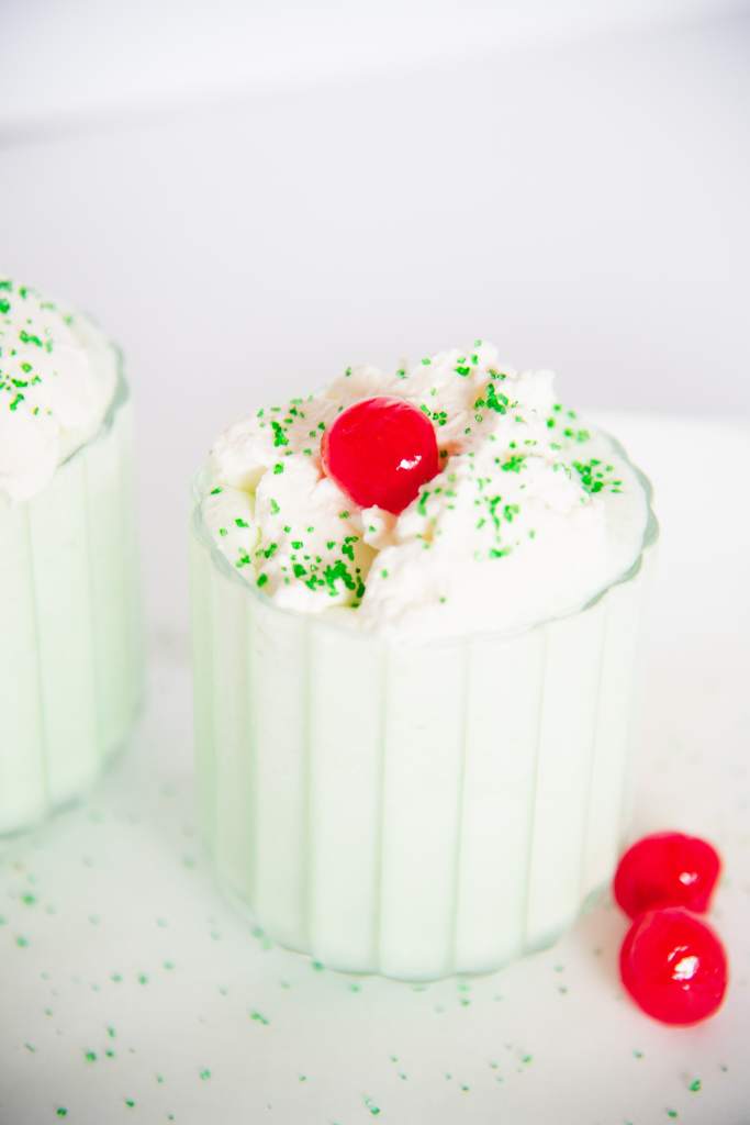 a finished shake with a cherry on top and two cherries on it 