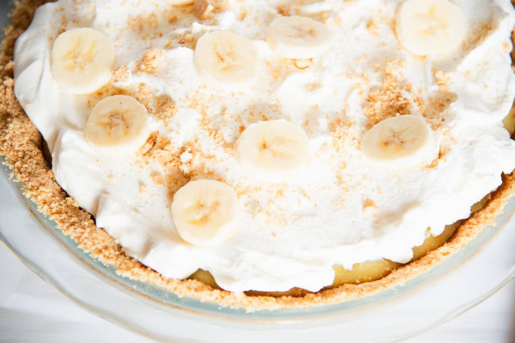 a cut off picture of a banana cream pie in a glass pie dish