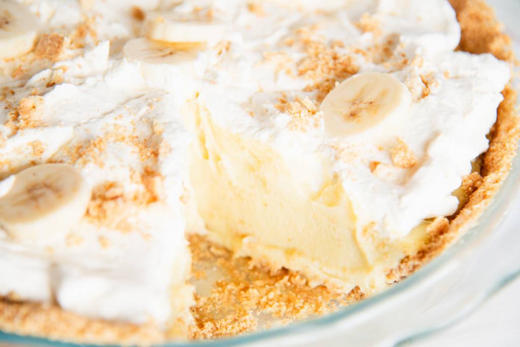 a close up of a banana cream pie with a slice taken out