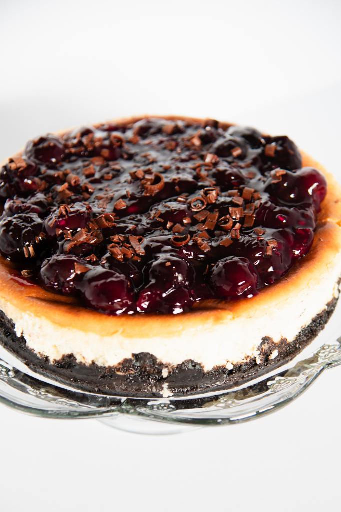 a black forest cheesecake with chocolate curls on top