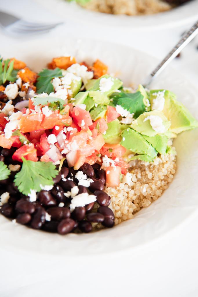 a close of a finished Mexican quinoa bowl with a fork in it