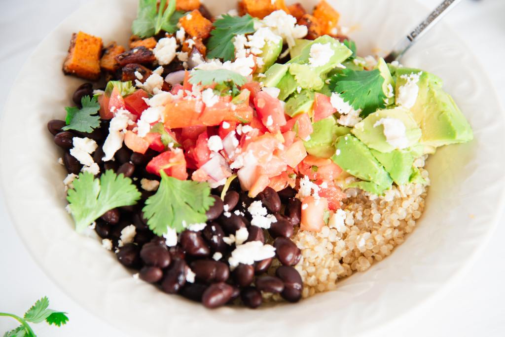 a close up of a finished Mexican quinoa bowl with a fork in it 