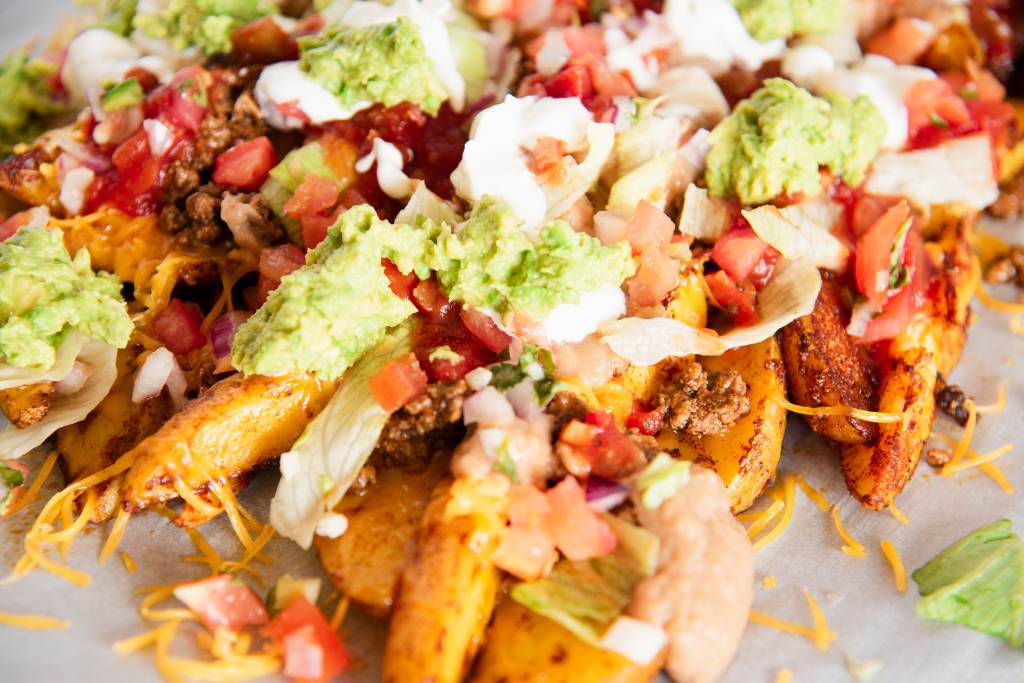 a close up of plate of nacho fries