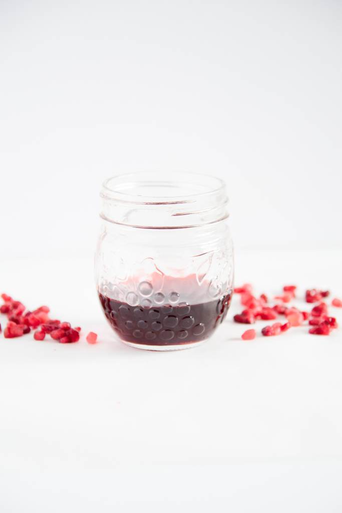 a jar with pomegranate simple syrup in