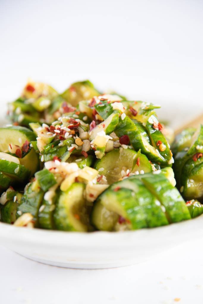 a close up of a bowl of spicy Asian cucumber salad 