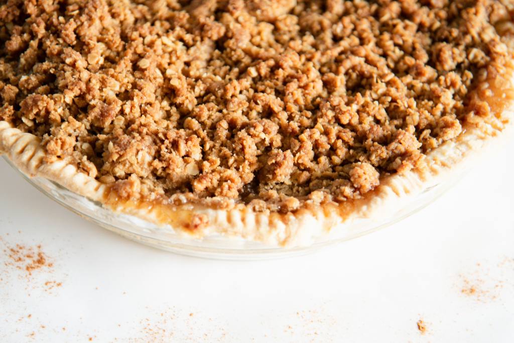 a very close up of an uncut dutch apple pie