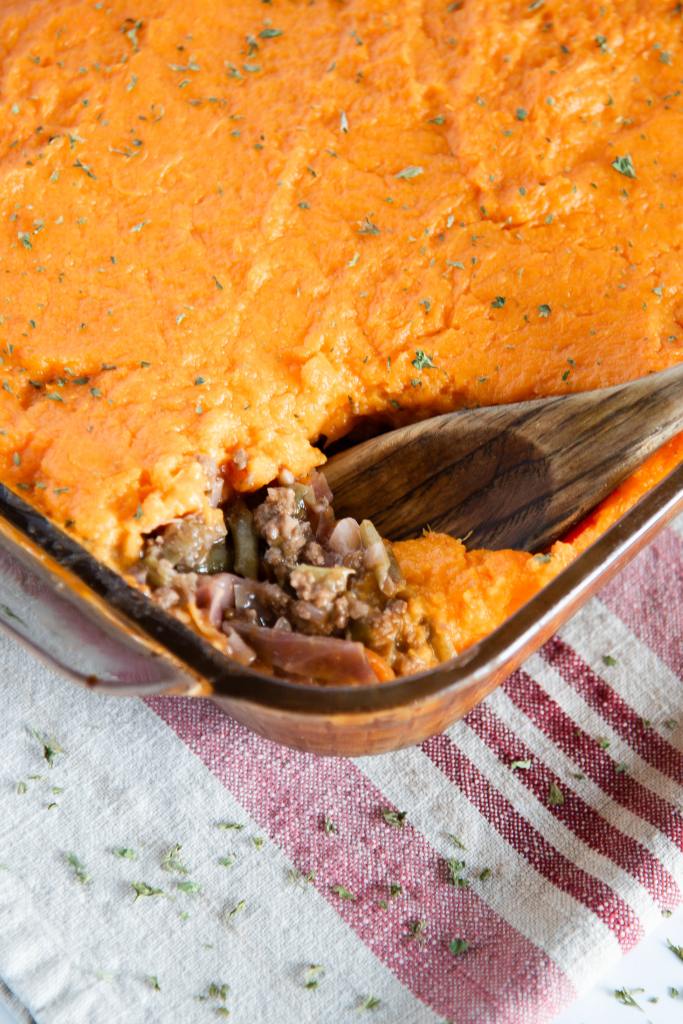 a pan of shepherd's pie with a wooden spoon in it 