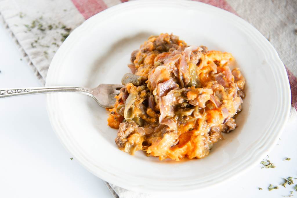 a plate of shepherd's pie with a fork in it