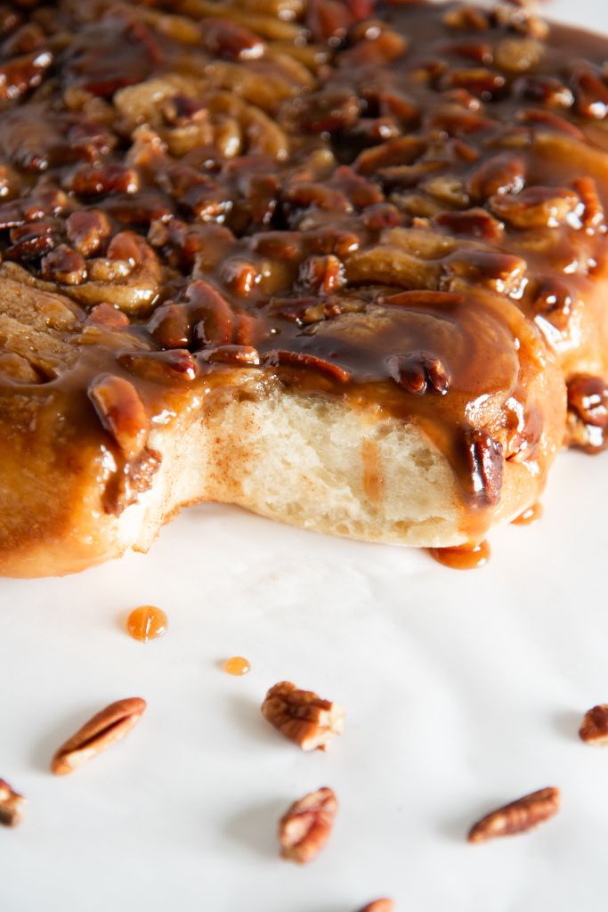 pecan sticky buns with one taken out of it