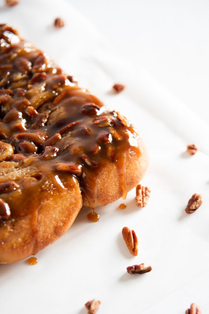 a cut off picture of sticky buns with chopped pecans around it