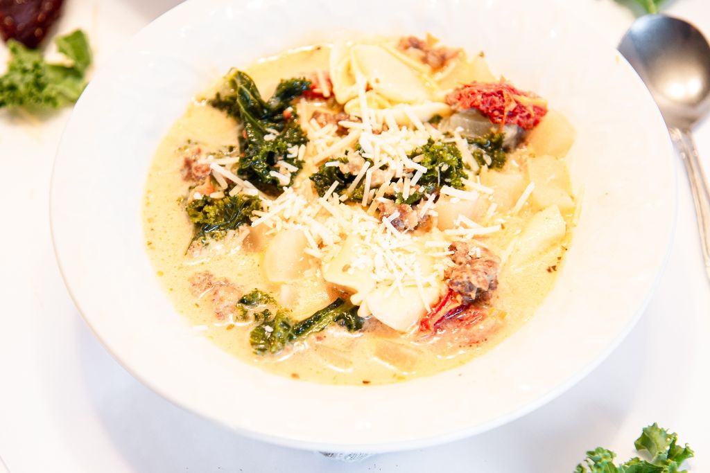 a bowl of soup with a spoon next to it