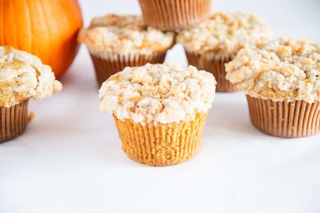 pumpkins muffins, with a pumpkin next to them