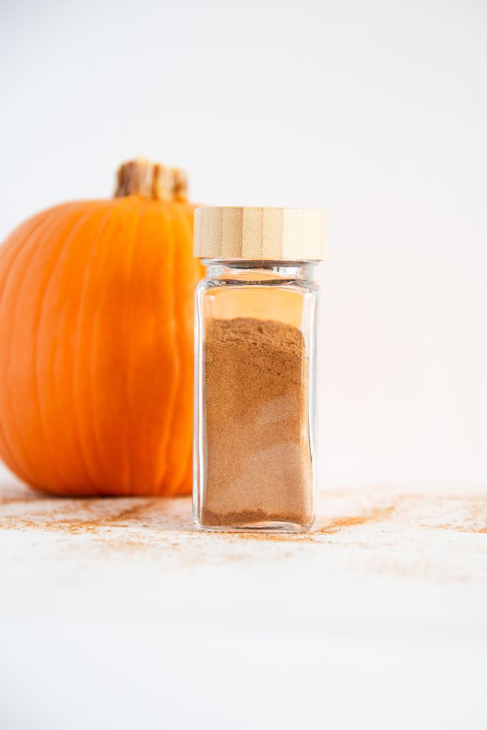 a close up of a glass spice bottle of pie spice