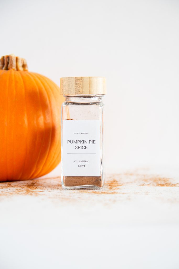 a bottle pumpkin pie spice with a label, you can see part of a pumpkin behind it