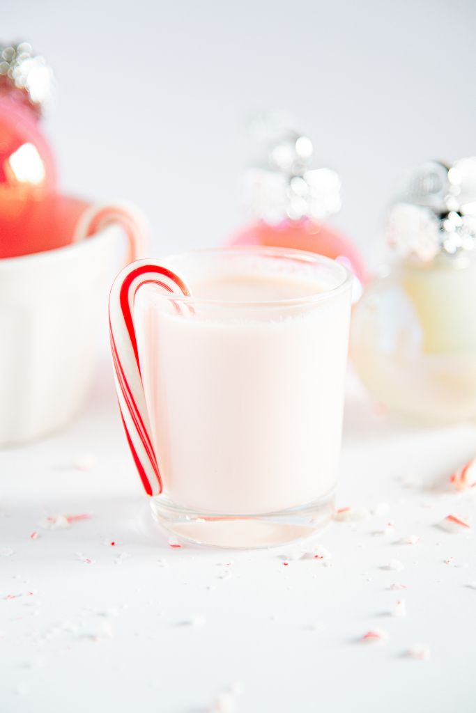 a candy shot with a mini candy cane hung on the edge of it