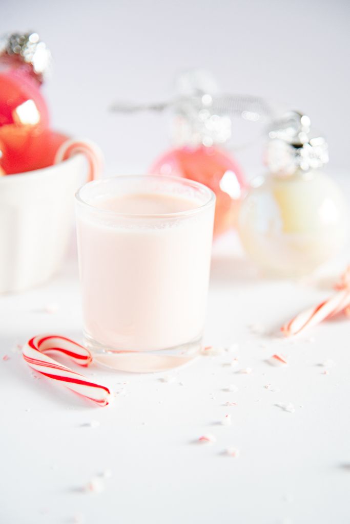 a finished candy cane shot with a mini candy cane set next to it 