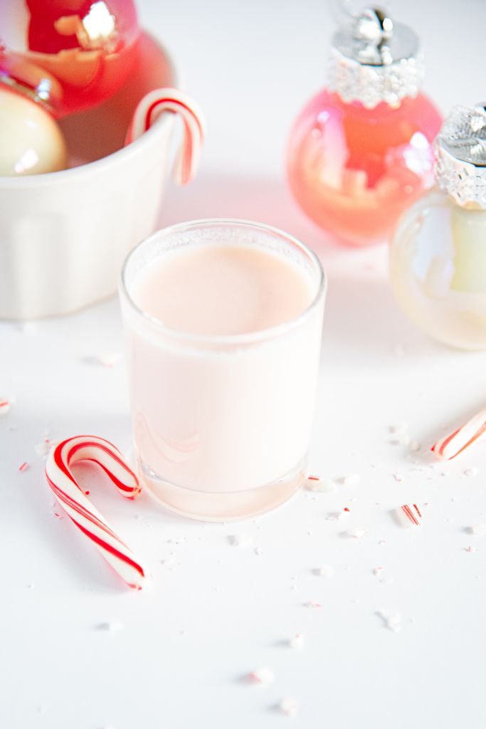 a candy cane shot with a mini candy cane set next to it