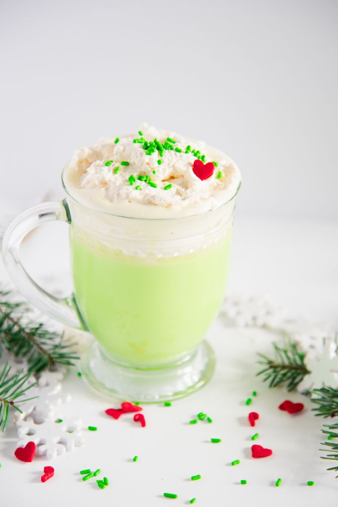 an overhead shot of Grinch hot chocolate with sprinkles on top