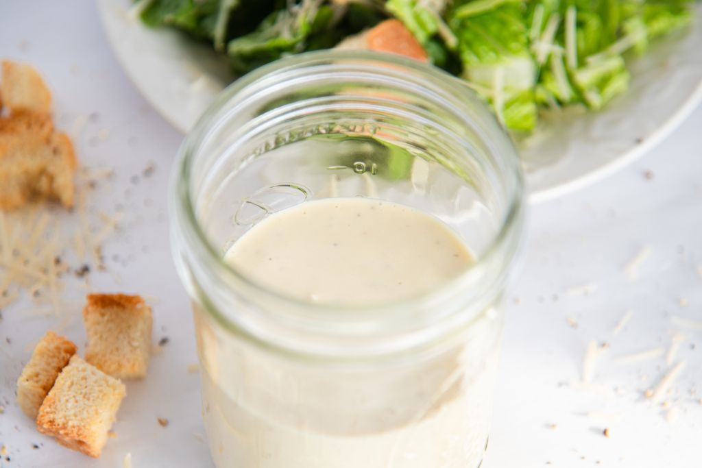 an overhead shot of a jar of Caesar salad dressing 