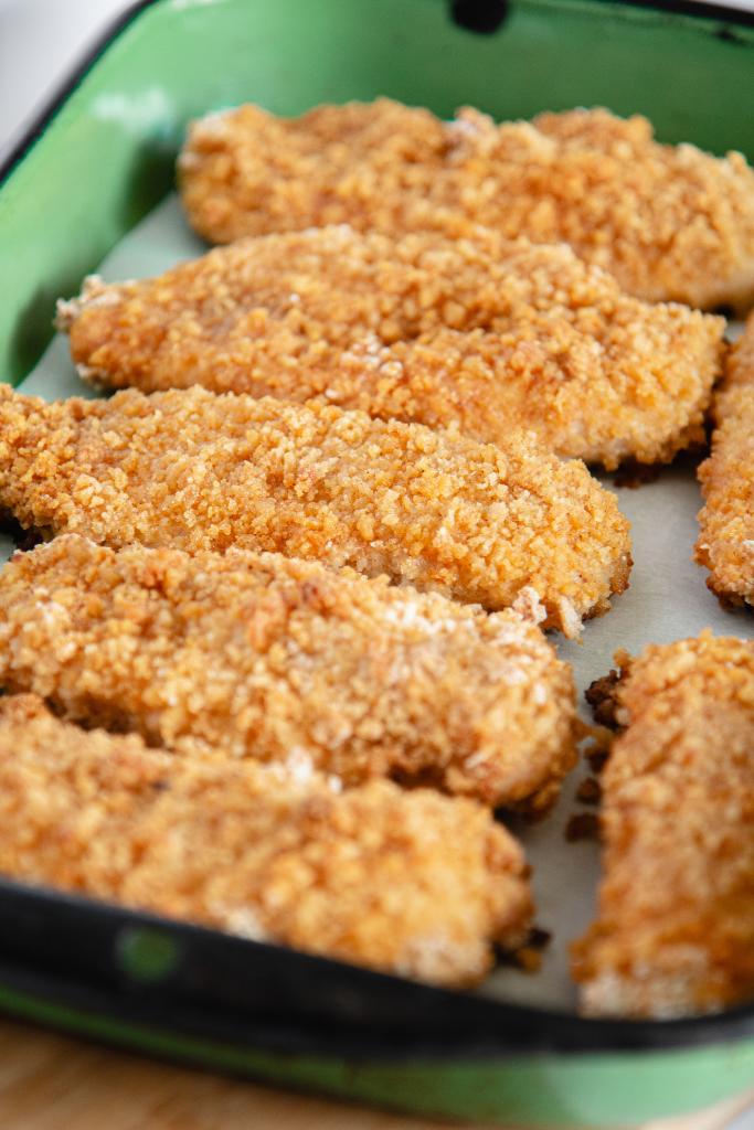 a green dish of fried chicken