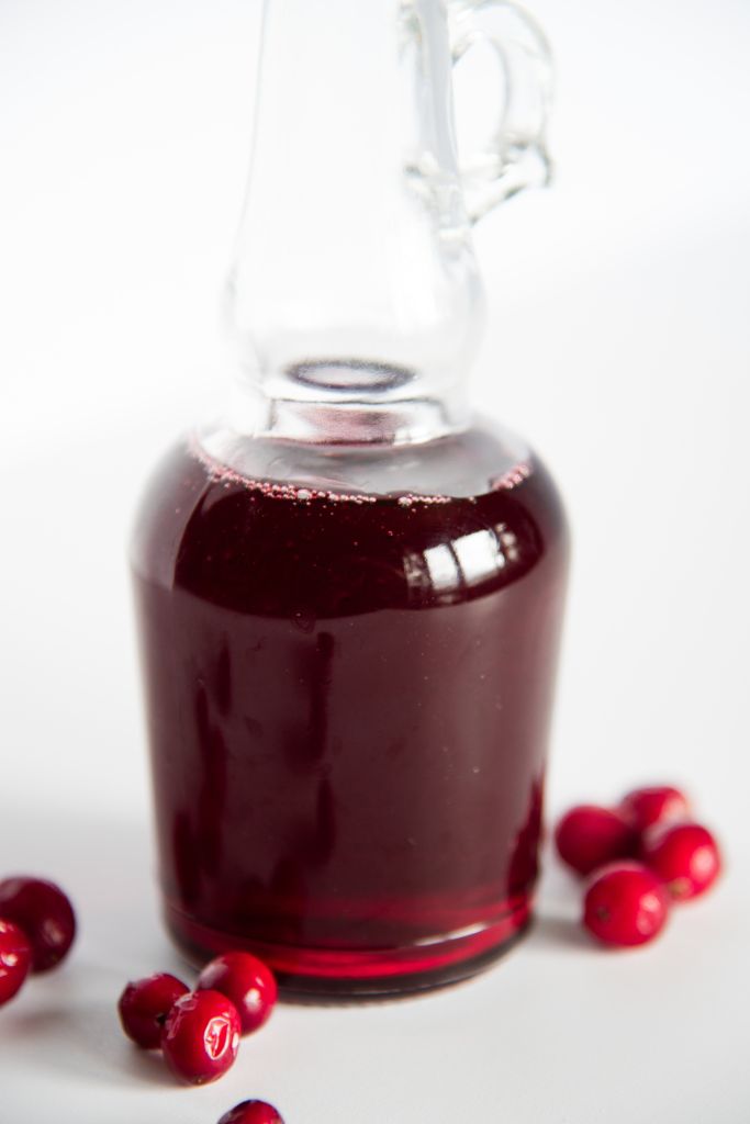a close up of a bottle of cranberry simple syrup 