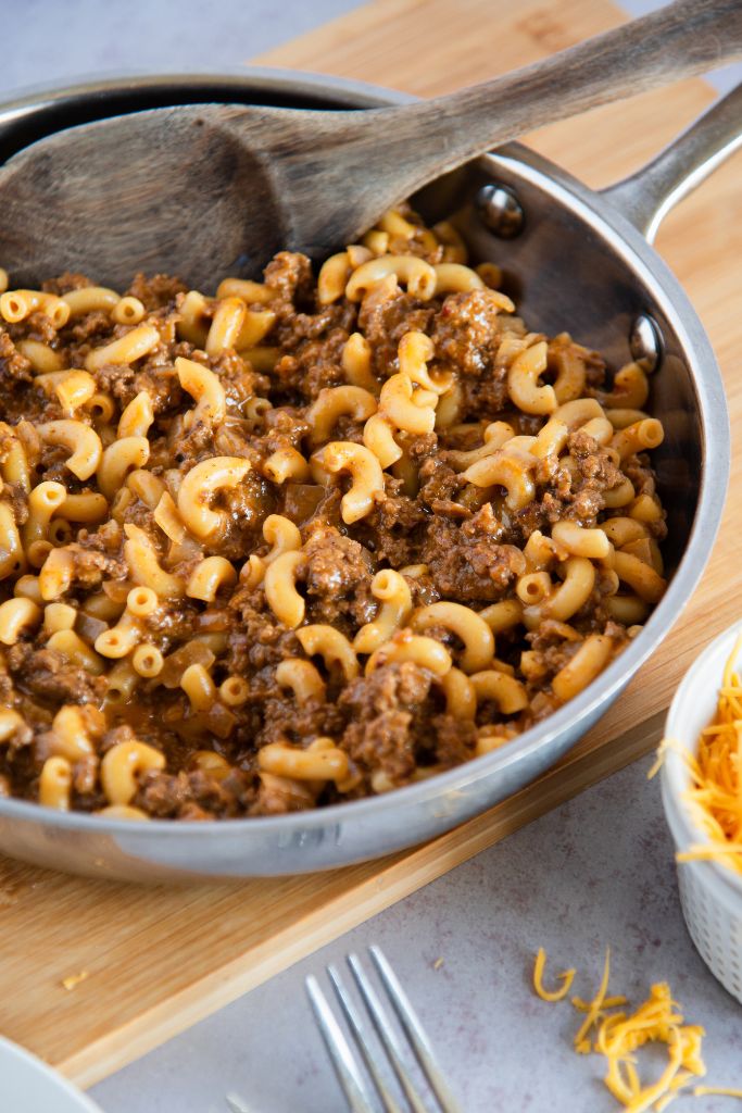 a pan of hamburger helper with a spoon in it 