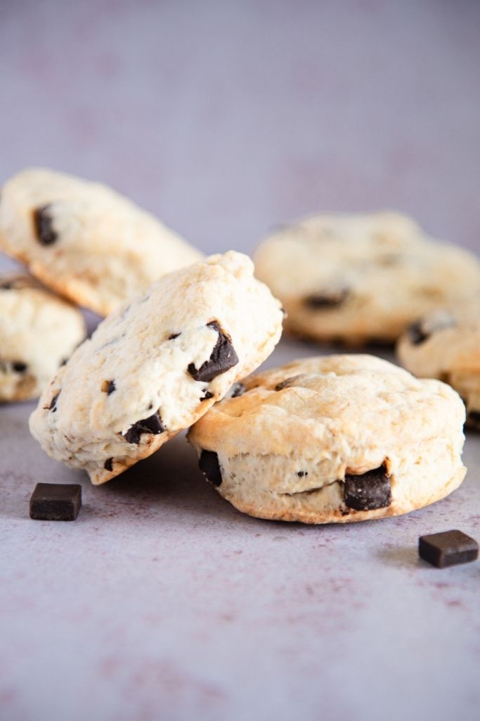a chocolate chunk biscuit set on top of another biscuit 