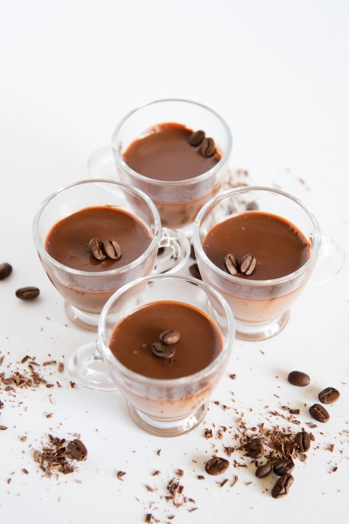 finished coffee shots with coffee beans and chocolate shavings around them 