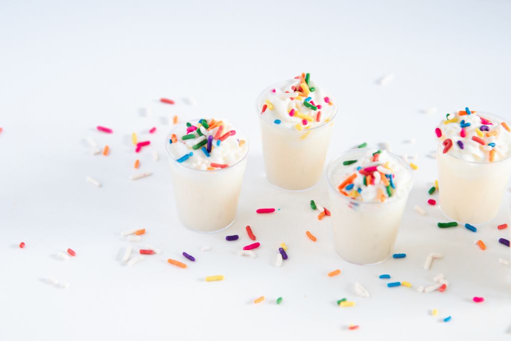 finished birthday cake shots with sprinkles around them
