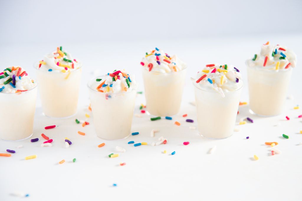 birthday cake shots with sprinkles around them