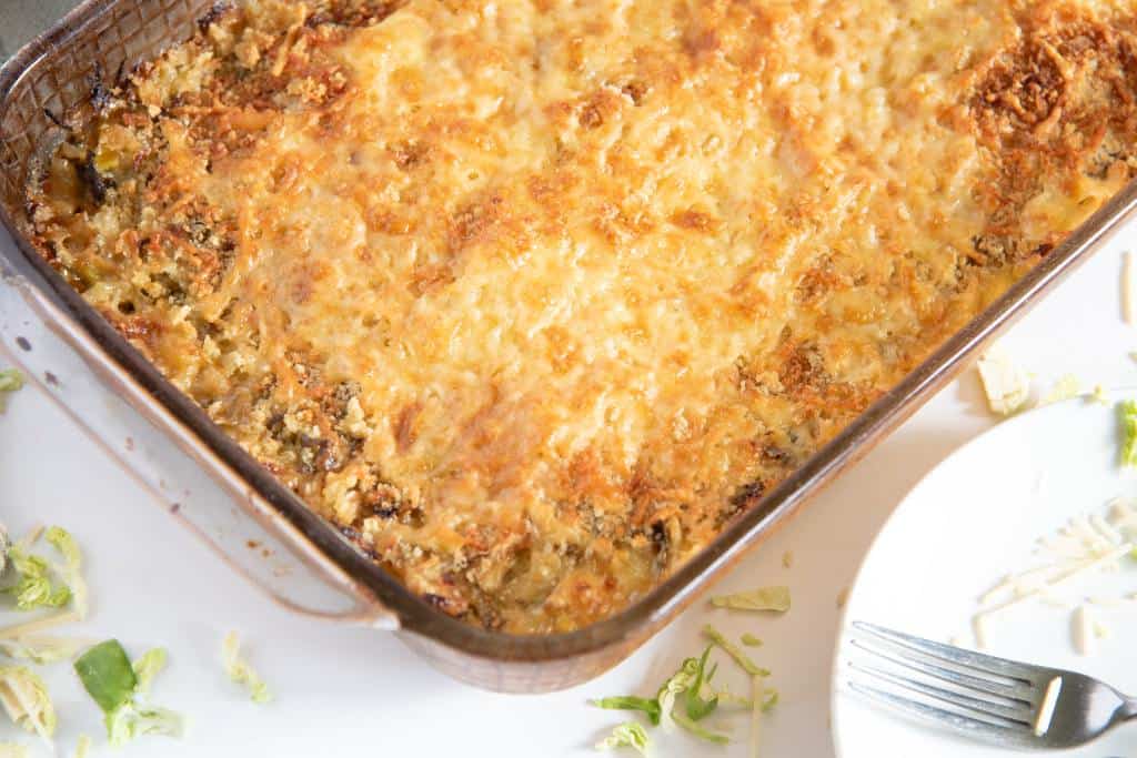 a pan of gratin with plates next to it 