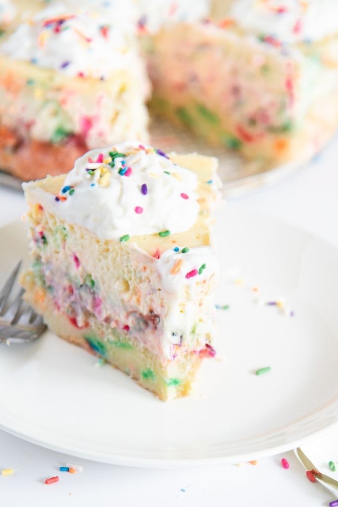 a close up of a slice of cheesecake on a plate, there is also a fork on the plate