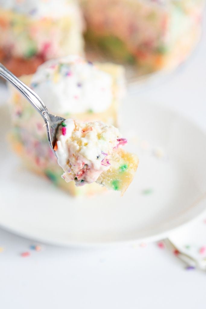 a fork full of birthday cake cheesecake