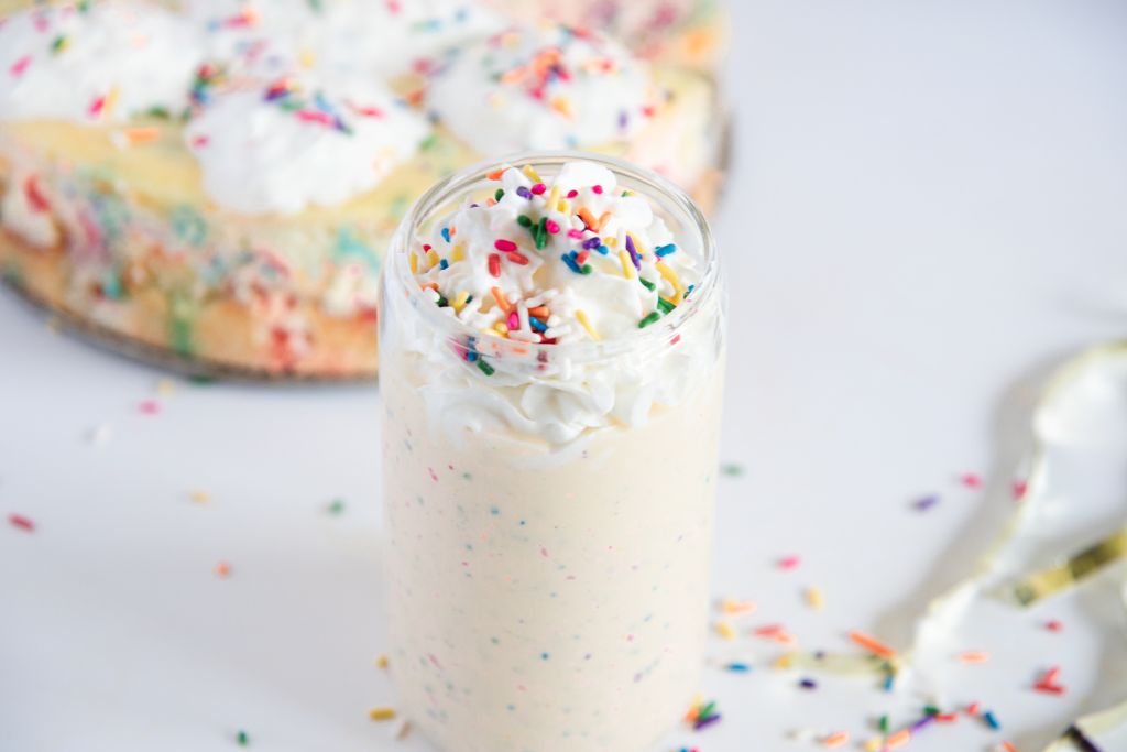 an overhead milkshake with a shake behind it