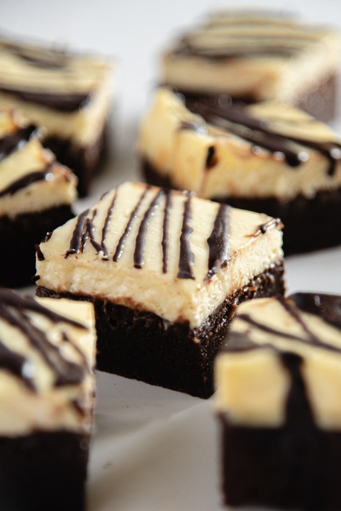 a close up on the top of a cheesecake brownie 