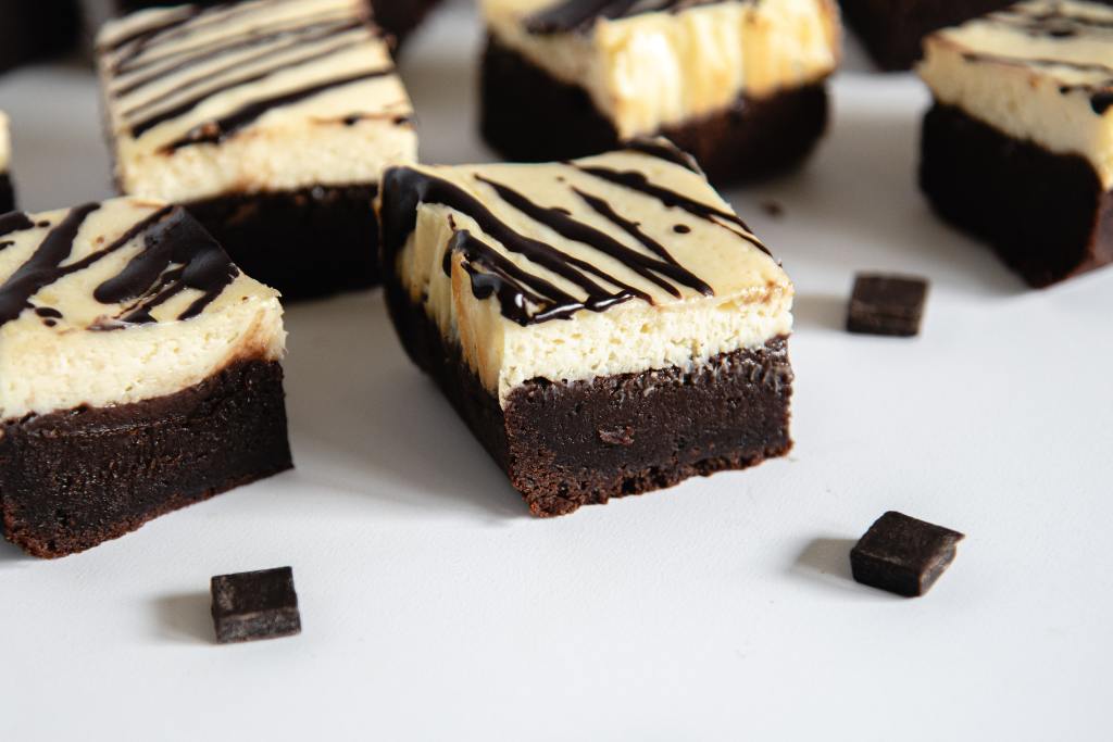 a close up on the side of a cheesecake brownie 