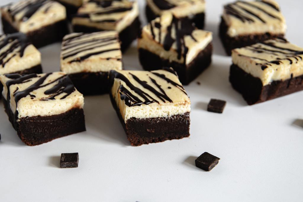 cheesecake brownies with chocolate chunks around them 