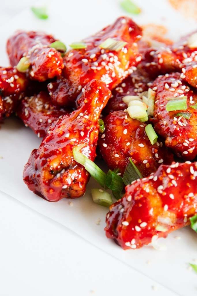 a close up of chicken wings piled on top of each other 