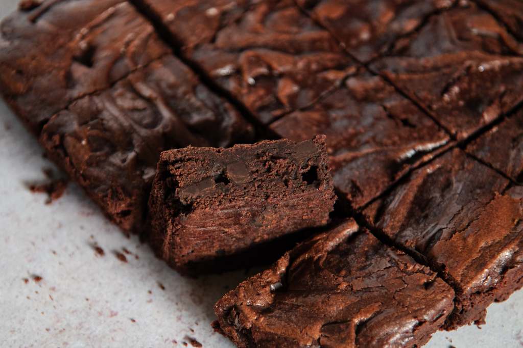 a sheet of cut brownies, but one brownie has been turned on it's side 